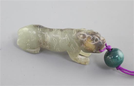 A Chinese celadon and black jade figure of a crouching tiger, Song dynasty style and possibly of the period, length 4.5cm